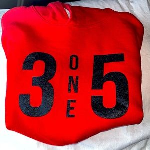This is a red crop hoodie with black lettering